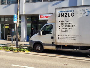 A white moving truck labeled 